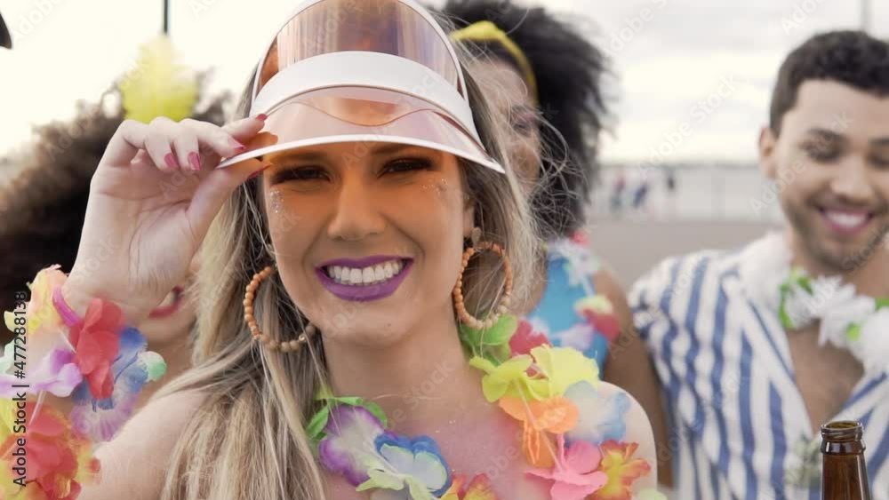 Carnaval in Brasil, blonde woman jumping with bier bottle at brazilian party in costume