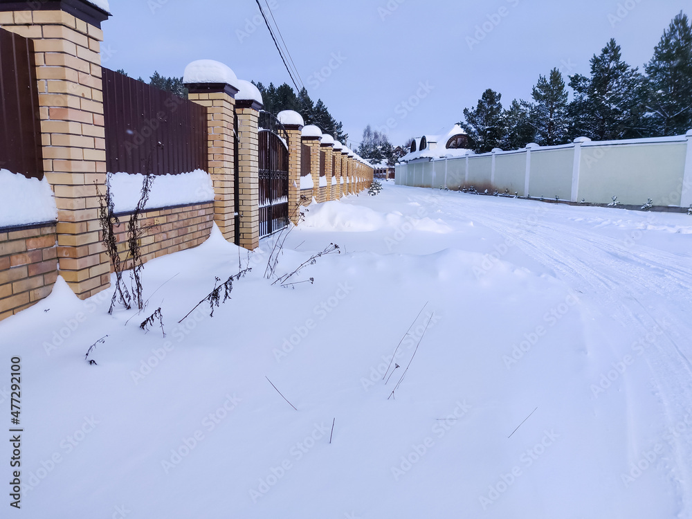 Country  rough road on snow in winter season. Russian rural outdoor landscape.