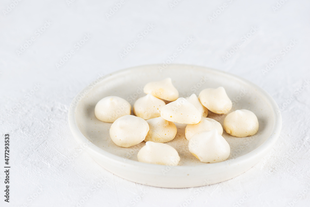 Aquafaba meringue on a plate. Sugar, lactose free, vegan dessert. Aquafaba meringue on a plate. Sugar, lactose free, vegan dessert.