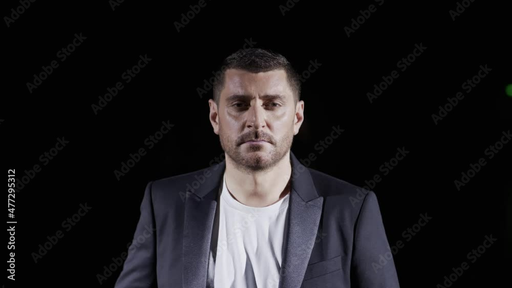 Caucasian courageous man standing in a dark room 4K. Empathy, emotions, excitement, sadness Caucasian courageous man standing in a dark room 4K. Empathy, emotions, excitement, sadness