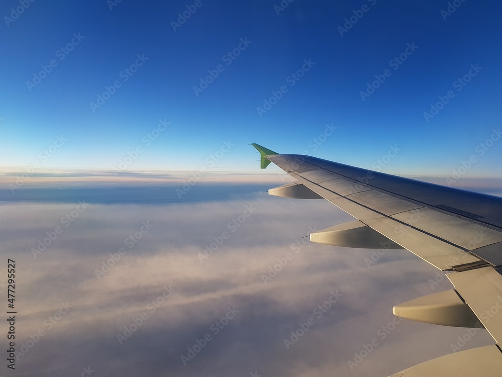 Obraz premium The plane flies among the clouds