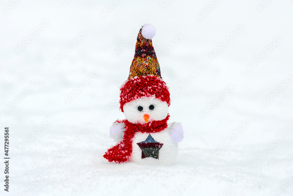 Merry christmas and happy new year greeting card with copy space Happy little snowman in red cap and scarf standing in winter snow background Xmas fairytale Hello January, February concept