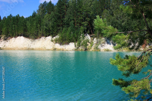 Trees grow on the shores of a turquoise lake