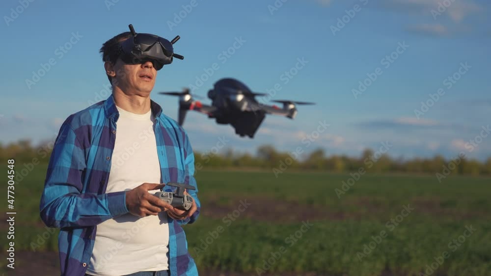 agriculture. man farmer a aerial pilot drone survey explorers green wheat crops in the field. agriculture modern business concept. man farmer works in field. nature drone technology in agriculture agriculture. man farmer a aerial pilot drone survey explorers green wheat crops in the field. agriculture modern business concept. man farmer works in field. nature drone technology in agriculture