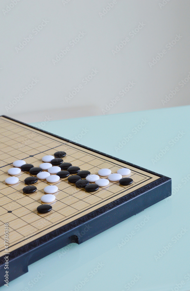 A corner of Go board games with white and black stones A corner of Go board games with white and black stones