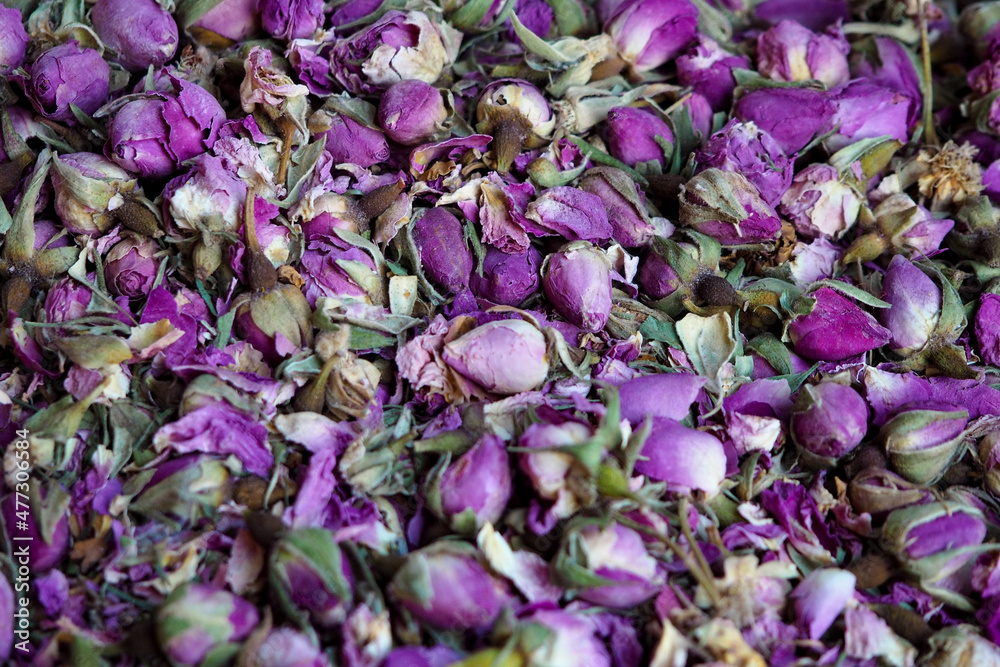 Pile of dried rose flowers used as natural fragrances displayed on souk - traditional street market in Morocco