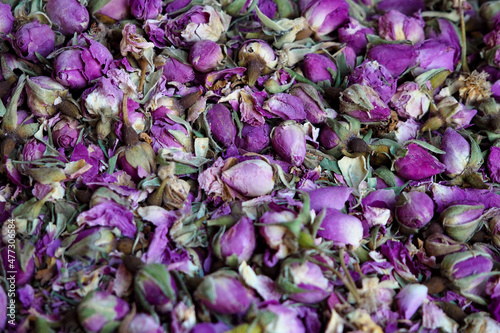 Pile of dried rose flowers used as natural fragrances displayed on souk - traditional street market in Morocco
