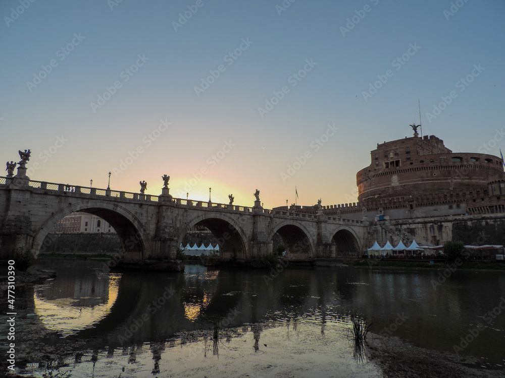 Beautiful view of Ponte Sant'Angelo (Sant'Angelo Bridge) reflected on the waters of the Tiber River and of Castel Sant'Angelo - Rome, Italy