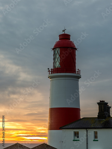 The red and white striped, 23 meter tall, Souter Lighthouse and the Leas in Marsden, South Shields, England, as the sun rises