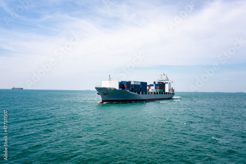 angle view in front container ship full speed in green sea, business and industry transportation import export international by container ship open sea