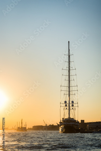 Fototapeta Naklejka Na Ścianę i Meble -   Luxury sailing yacht boat docked in Port of Venice, Italy with other cruise ship liners and Venetian skyline on Giudecca Canal on summer day