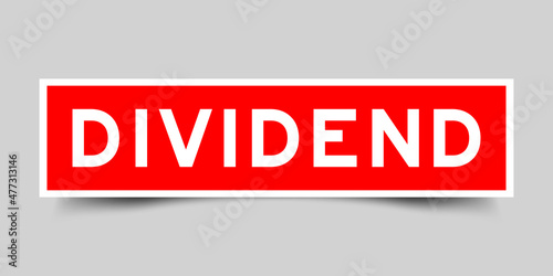 Sticker label with word dividend  in red color on gray background