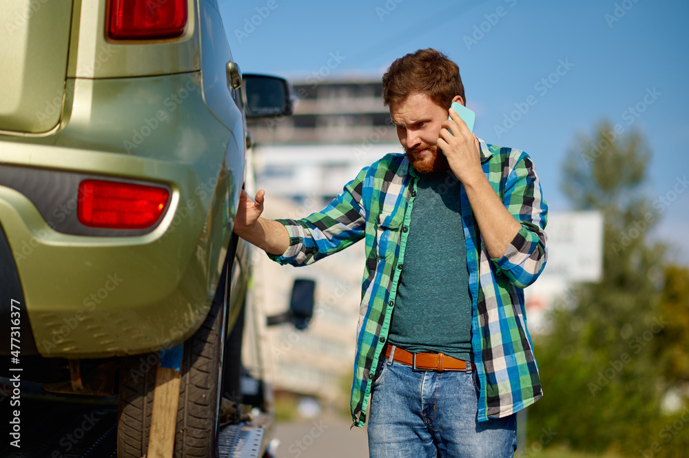 Man driver discussing occurrence by mobile phone