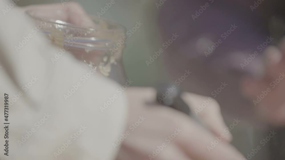 Quince jam is placed in a jar. Slow Motion 100fps Quince jam is placed in a jar. Slow Motion 100fps
