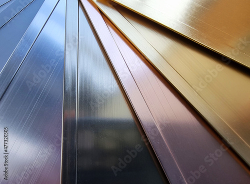 rose gold, bronze, silver, gold and black brushed stailess metal samples catalog in close up view. variety color of real hairline aluminum samples for interior coating, finishing, furnishing works. photo