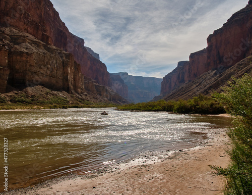 Rafters on the Colorado River in the Grand Canyon, passing the beach at Nankoweap Camp. photo