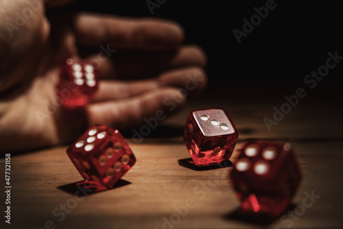 Canvas hand rolling dice. risk, luck and gambling concept