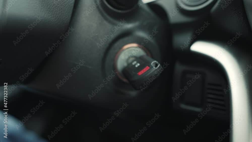 Man starts the car with the key Man starts the car with the key