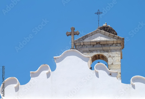 Arco da Vila, gate to the old town of Faro in Portugal, historic building with stork nest