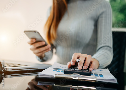 Businessman hands working with finances about cost and calculator