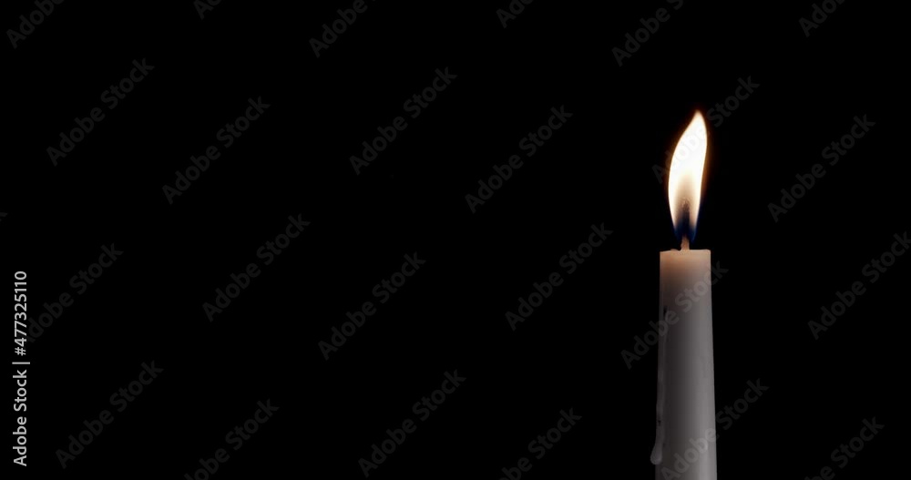 Candle on a black background. The flame of the candle slowly flickers. One candle slowly flickers. Ideal for background or over-layer with blending mode add, screen, lighten. Candle on a black background. The flame of the candle slowly flickers. One candle slowly flickers. Ideal for background or over-layer with blending mode add, screen, lighten.