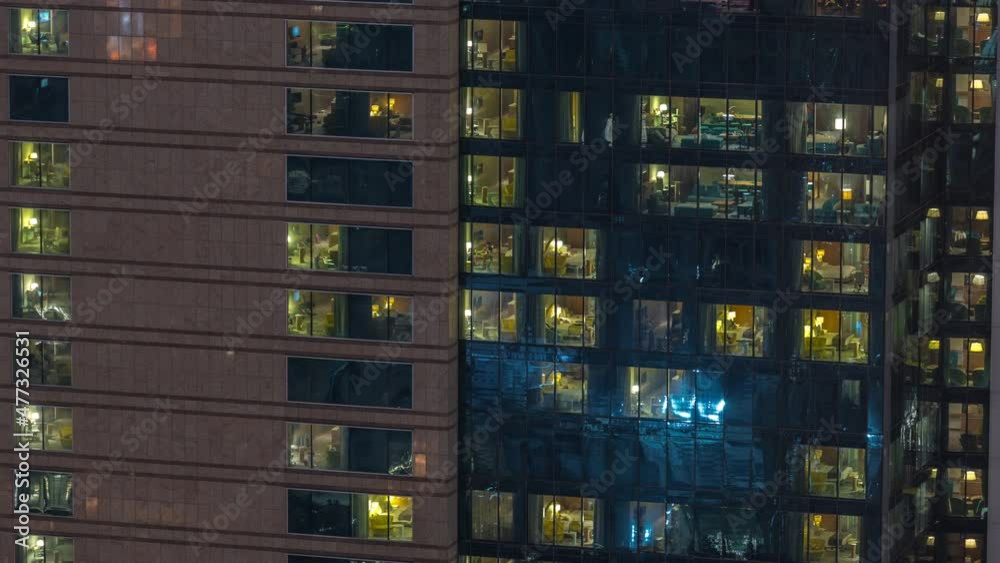 Outside view of windows in apartments of a high class building at night timelapse Outside view of windows in apartments of a high class building at night timelapse