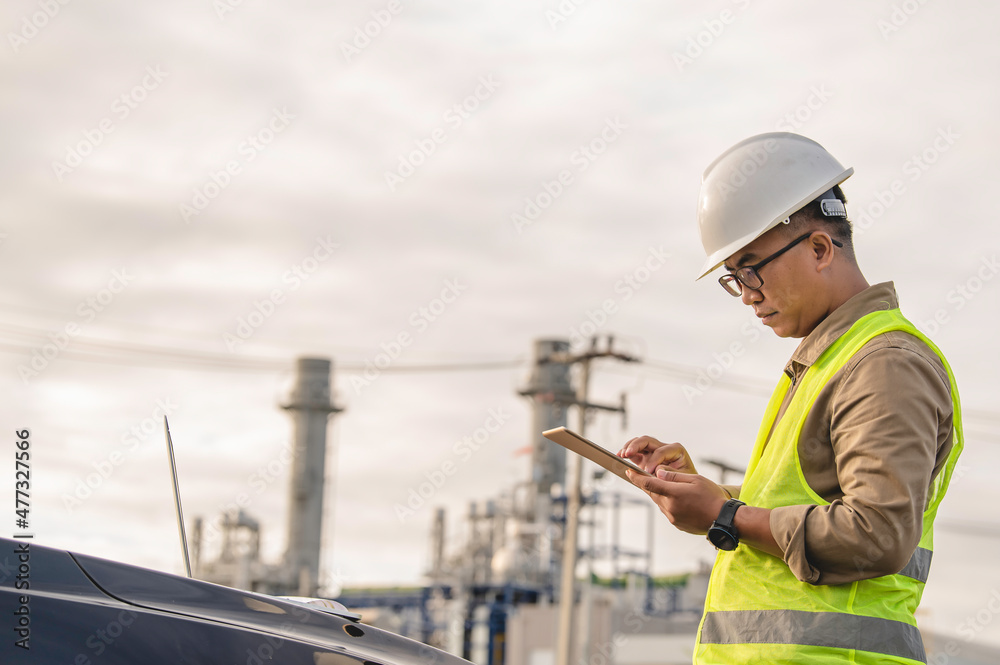 Asian man petrochemical engineer working at oil and gas refinery plant