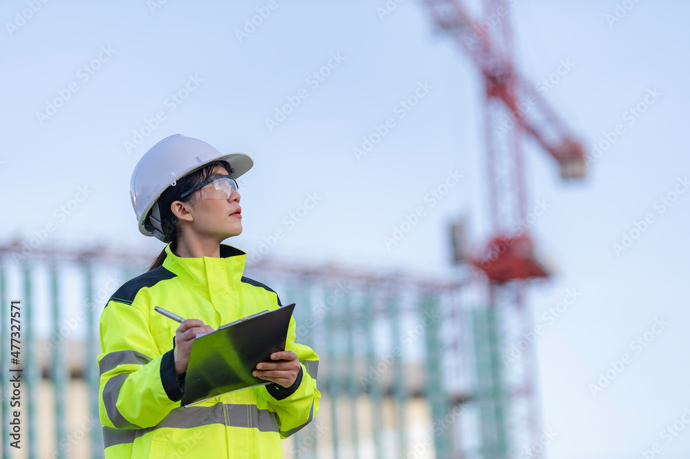 Asian engineer working at site of a large building project,Thailand people,Work overtime at construction site Asian engineer working at site of a large building project,Thailand people,Work overtime at construction site