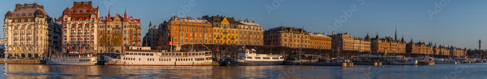 Panorama view at the bay Nybroviken and street Strandvägen with commuting boats and apartments, hotels and office buildings a snowy winter day afternoon in Stockholm