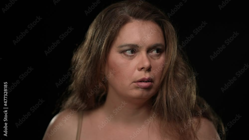 Close-up portrait scared plus size woman looking around with worried facial expression closing face with hands. Stressed frightened Caucasian lady hiding from danger posing at black background Close-up portrait scared plus size woman looking around with worried facial expression closing face with hands. Stressed frightened Caucasian lady hiding from danger posing at black background