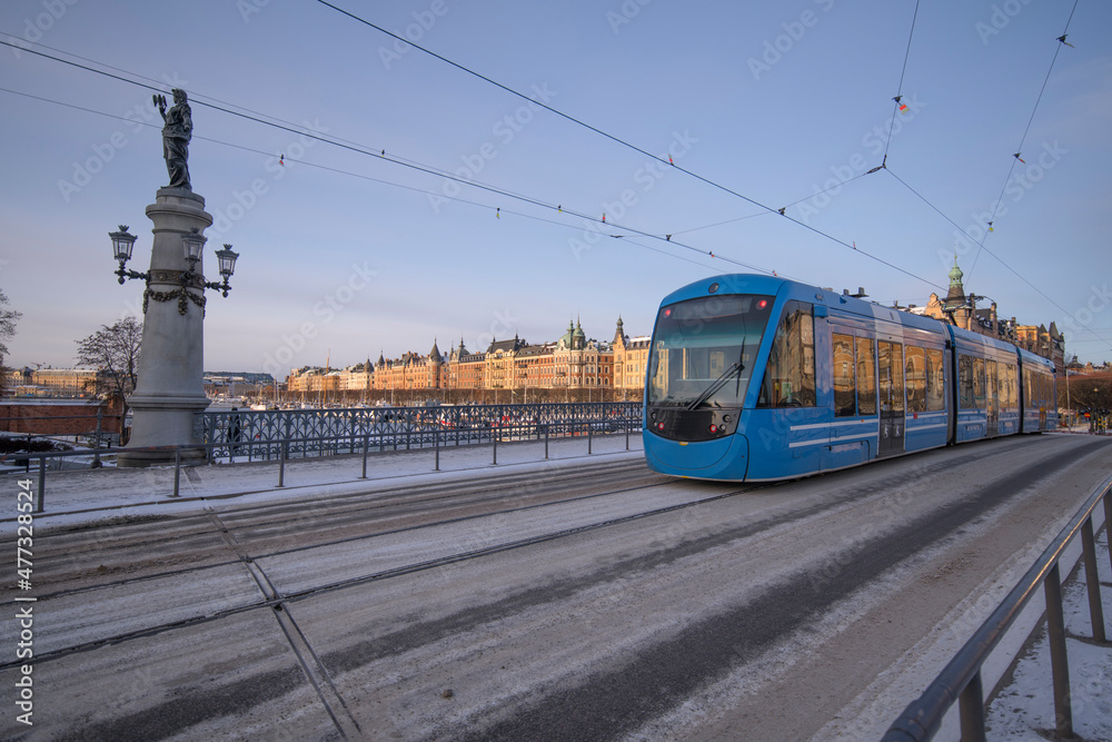 Tram on the bridge Djurgårdsbron a sunny frosty winter day in Stockholm