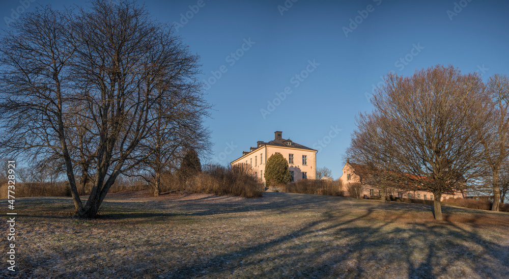 Fototapeta premium Old profane castle building from 1650s, Hässelby slott in its park a sunny frosty winter day in Stockholm