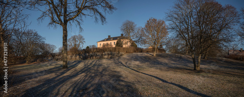 Old profane castle building from 1650s, Hässelby slott in its park a sunny frosty winter day in Stockholm photo