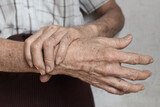 Hands of Asian elder man. Concept of joint pain, arthritis or hand problems.