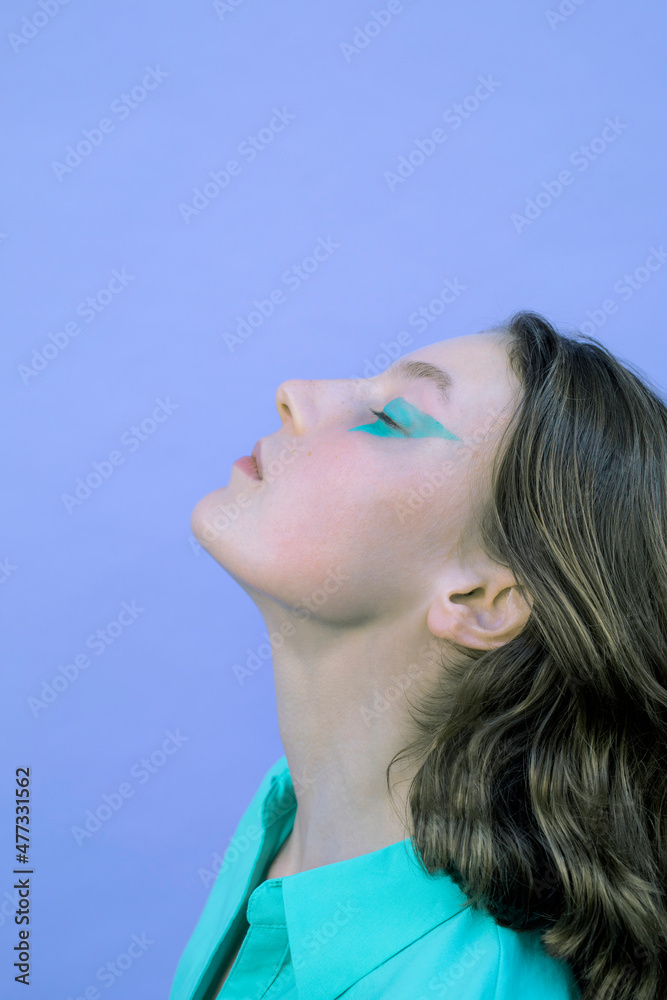Girl with eye make-up by lavender background Girl with eye make-up by lavender background