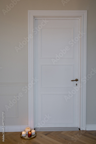 Candles next to the white front door Romantic atmosphere