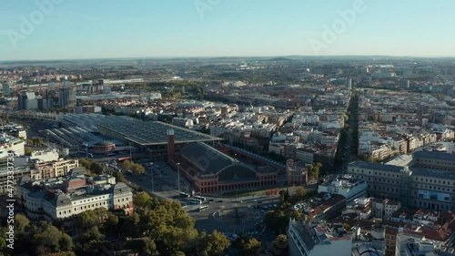 Aerial panoramic footage of Atocha district with train station. Traffic in streets and on roundabout.