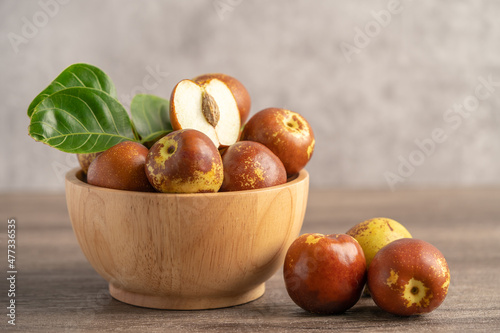 Jujube fruit or Chinese Dates in wooden bowl, healthy food.