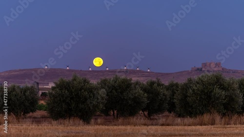 Full Moonset behind Consuegra iconic windmills