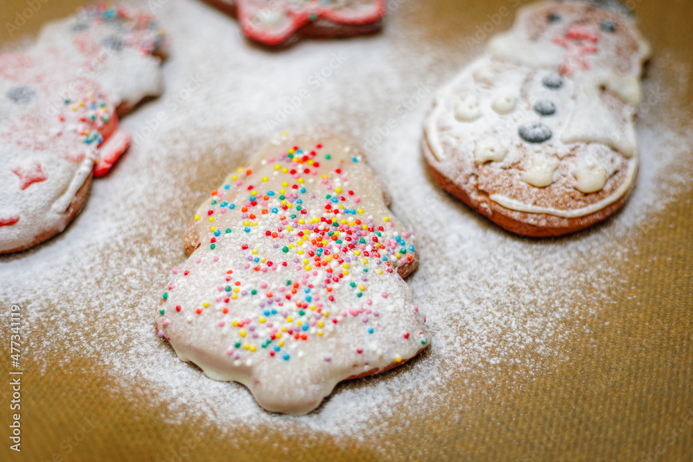 Christmas cookies sprinkled with icing sugar on a baking sheet. Christmas cookies sprinkled with icing sugar on a baking sheet.