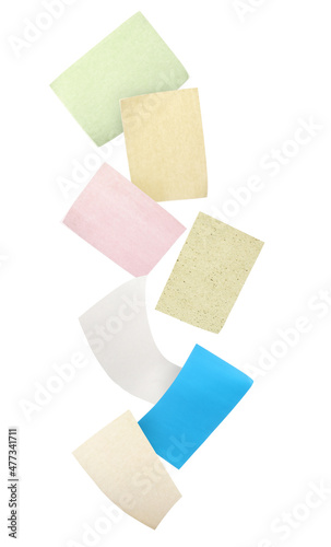 Different facial oil blotting tissues falling on white background. Mattifying wipes