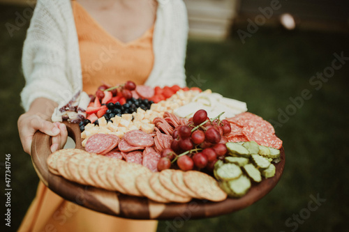 Hands holding Charcuterie Board 