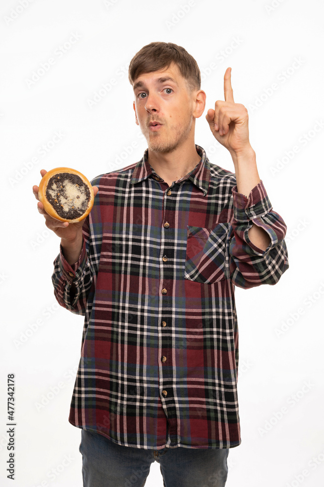 Young handsome tall slim white man with brown hair holding kolach coming up with idea in flannel shirt isolated on white background Young handsome tall slim white man with brown hair holding kolach coming up with idea in flannel shirt isolated on white background