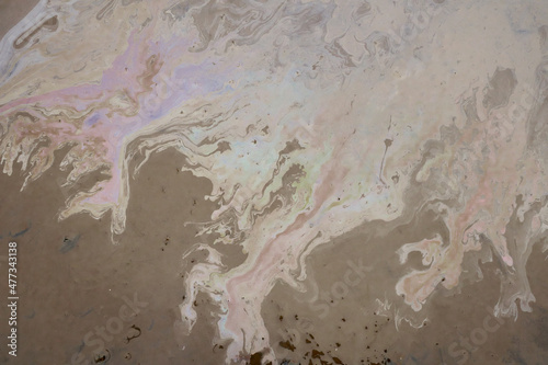 Beautiful abstract stain of motor oil, gas or petrol spilled on the asphalt. Marbling background