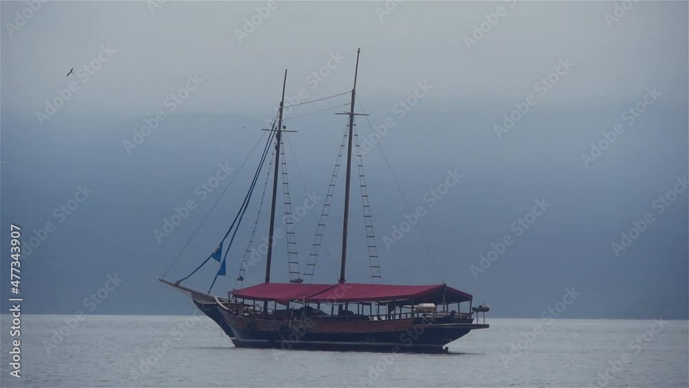 One Sailing Yacht On Calm Water In Foggy Weather One Sailing Yacht On Calm Water In Foggy Weather