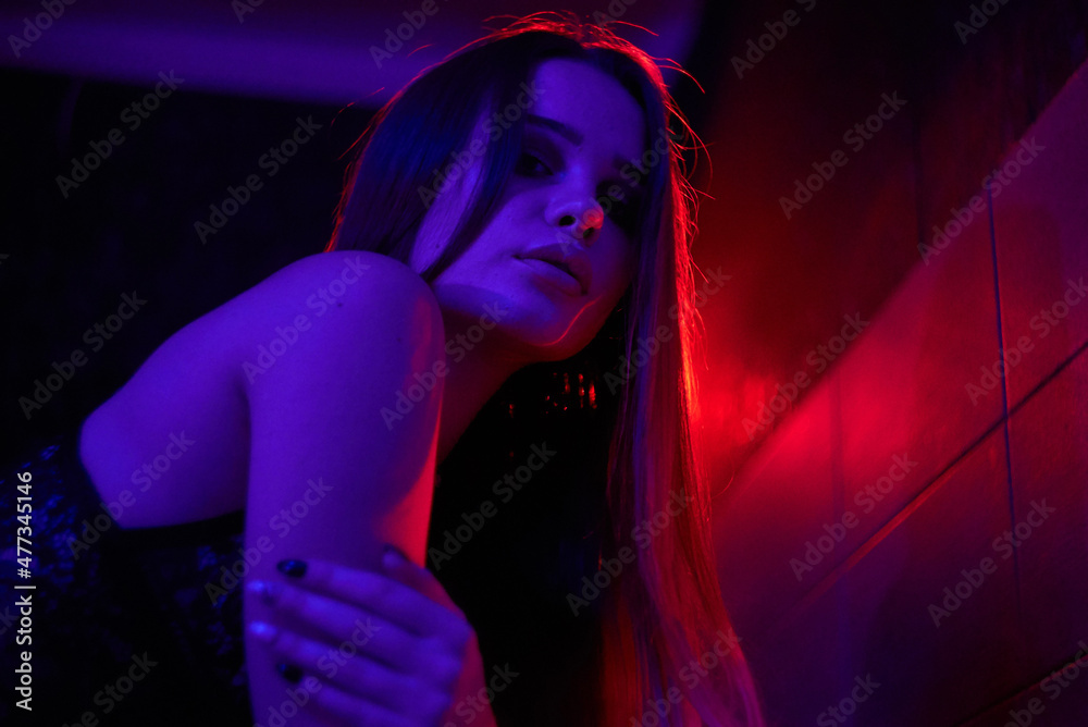 Woman in Neon Lighting Close Distance Lips Beauty. High quality photo