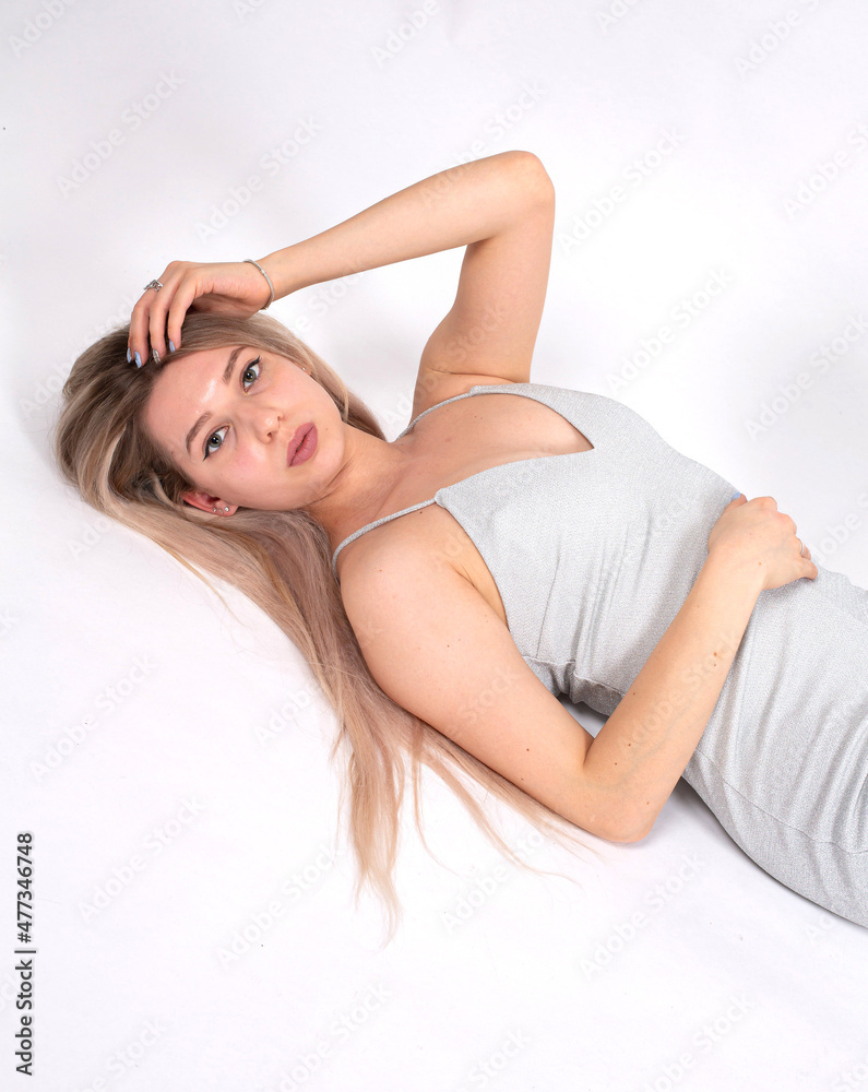 Blond hair young european woman with white skin isolated on grey with hand near the face Blond hair young european woman with white skin isolated on grey with hand near the face