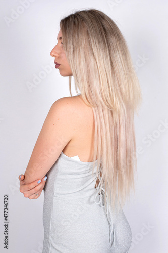 Young european woman with white skin isolated on grey with blonde hair