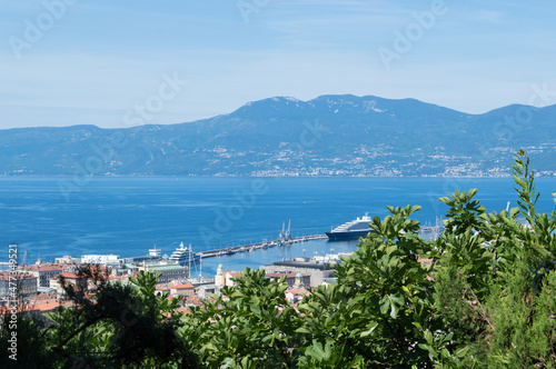 Rijeka, Croatia, a panoramic view over the city, beautiful Adriatic sea and Učka mountains, a view through a fig tree