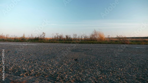 Close-up Asphalt Road Country Highway Near Field. Autumn Season. Evening Sunset Sun Sunshine. Europe Rural Scene Background. 2x Slow motion 60fps 4K photo